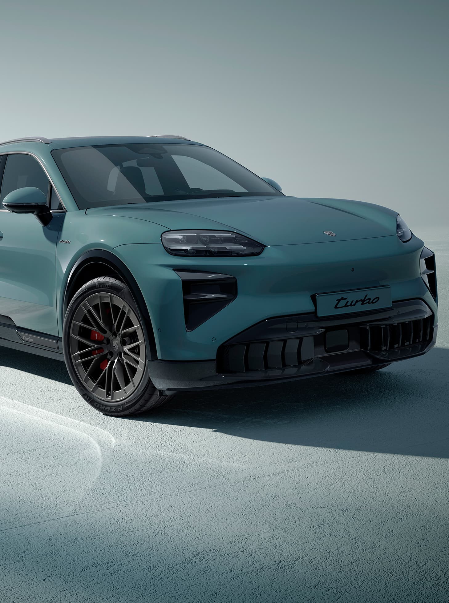 A Porsche Cayenne driving on an open road.